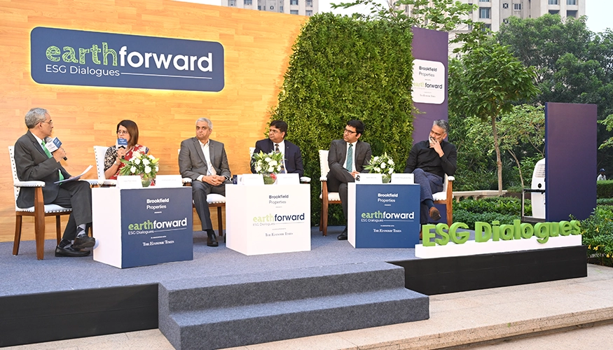 Panel discussion at Downtown Powai’s ‘Earth Forward ESG Dialogues’ event, featuring speakers seated on stage with greenery in the background